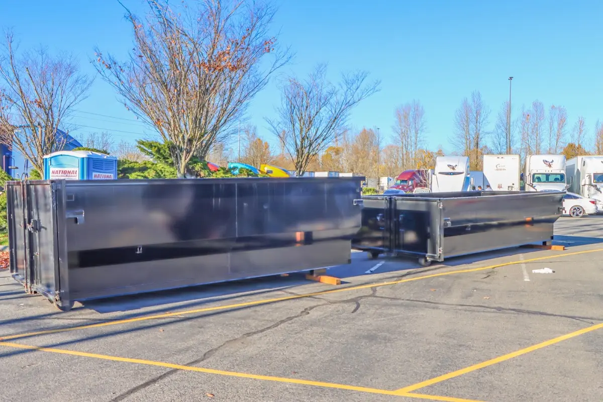 Professional dumpster rental service with roll-off container on residential driveway in Tallmadge